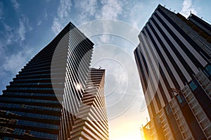 Modern glass office buildings against the sunset sky