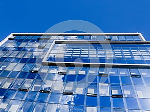 Modern glass office business building - clouds reflections