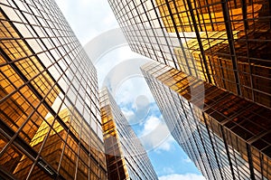 Modern glass skyscraper with blue sky and white clouds, Hong Kong