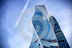 Modern glass skyscrapers against the blue sky and clouds, the building of the business center in Moscow, the City