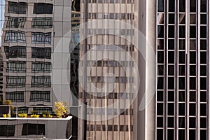 Modern glass windows in concrete building facade - urban modern architecture