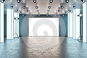 Modern glowing exhibition hall blank banner stage in concrete interior. Museum and gallery concept. Mock up