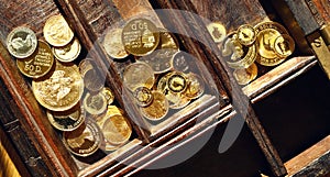 Modern gold coins in a wooden casket