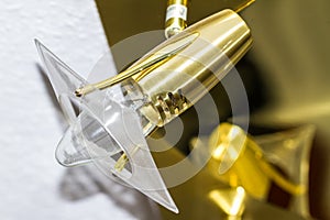 Modern gold and plastic electric light fitting