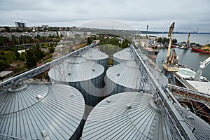 Modern grain terminal. Metal tanks of elevator. Grain-drying complex construction. Commercial grain or seed silos at