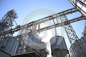 Modern granaries for storing cereal grains against blue sky, low angle view