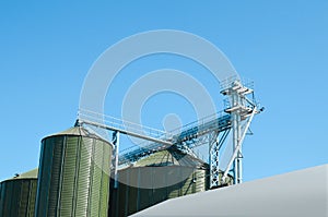 Modern granaries for storing cereal grains against blue sky, low angle view