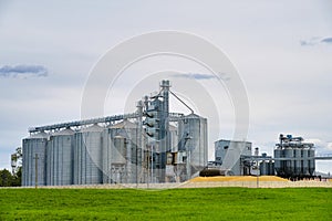 Modern granary elevator. Metal silos for grain storage, drying, cleaning agricultural products, flour, cereals and grain. Agro-