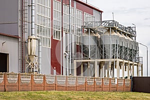 Modern Granary elevator and seed cleaning line. Silver silos on agro-processing and manufacturing plant for processing drying