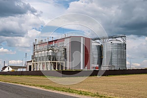 Modern Granary elevator and seed cleaning line. Silver silos on agro-processing and manufacturing plant for processing drying