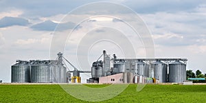 Modern Granary elevator and seed cleaning line. Silver silos on agro-processing and manufacturing plant for processing drying