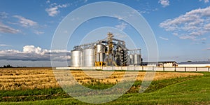 Modern Granary elevator and seed cleaning line. Silver silos on agro-processing and manufacturing plant for storage and processing