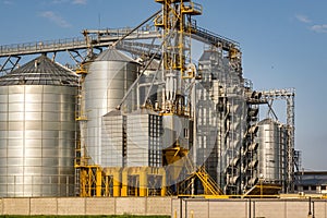 Modern Granary elevator and seed cleaning line. Silver silos on agro-processing and manufacturing plant for storage and processing