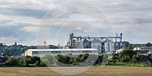 Modern Granary elevator and seed cleaning line. Silver silos on agro-processing and manufacturing plant for storage and processing