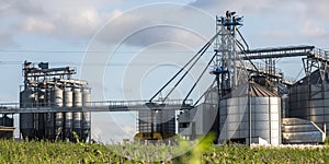 Modern Granary elevator and seed cleaning line. Silver silos on agro-processing and manufacturing plant for storage and processing