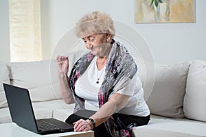 Modern grandma talking on the skype photo
