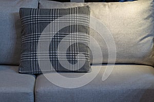Modern gray fabric pillow and checkered pattern on the cushion gray sofa interior
