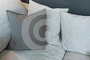 Modern gray fabric pillows on gray cloth sofa interior in living room decoration design building