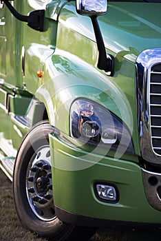Modern green rig semi truck details like fency big transport
