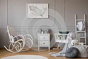 Modern grey baby nursery design in tenement house, copy space and poster on empty wall