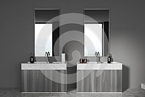 Modern grey bathroom interior with sink and two mirrors, window