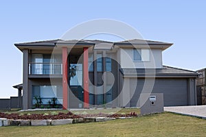 Modern grey house with red pillars