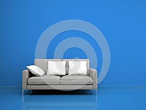 Modern grey sofa on the blue wall