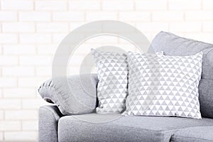 Modern grey sofa with pillows