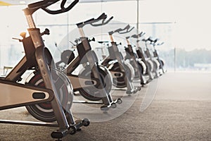 Modern gym interior with equipment, fitness exercise bikes