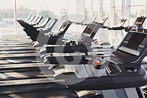 Modern gym interior equipment, treadmill control panels for cardio training
