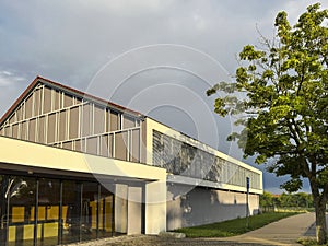 A modern gymnasium or gym building in warm golden hour light