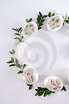 Modern hand painted easter egg on white background in the shape of a wreath. Happy easter poster and banner for greeting text.