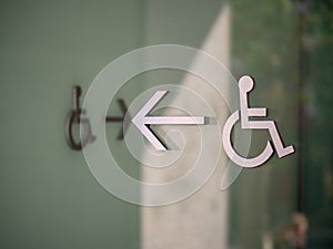 Modern handicap disabled logo pointing to left with another creating path