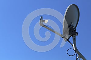Modern HD Satellite Dish On A Clear Blue Sky Day photo