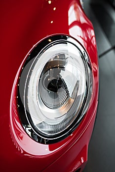 Modern headlight of sport red car