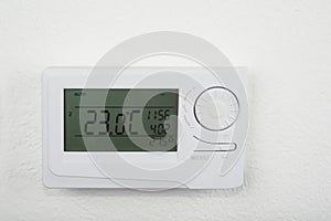 Modern heat thermostat on a white background