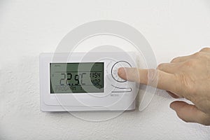 Modern heat thermostat on a white background