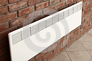 Modern heating con on brick wall