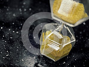 Modern hexagon hourglass with golden sand seed