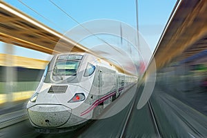 Modern hi-speed passenger train, in movement motion.