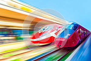 Modern hi-speed passenger train, in movement (motion) on railways station