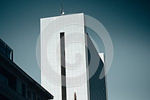 Modern high office building, tower, skyscraper facade against blue sky. Urban architecture City cityscape. Corporate