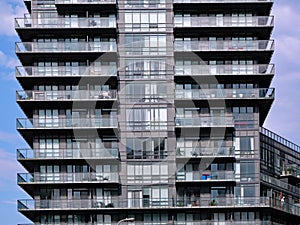 Modern high rise apartment building with floor to ceiling windows