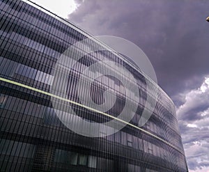 Modern high-rise building against a cloudy sky in Prague