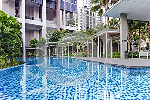 Modern high-rise residential apartment with a beautiful tropical garden and swimming pool