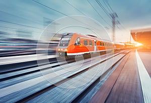 Modern high speed red passenger commuter train. Railway station