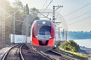 Modern high-speed train moves along the Black sea coast