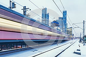 Modern high-speed train moves fast on the business center background
