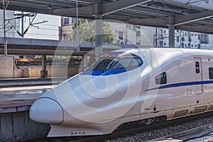 Modern high-speed train stands by the platform