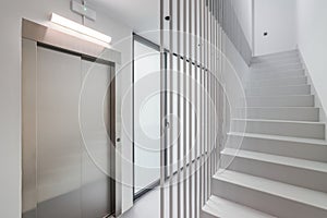 Modern high-tech style in the entrance of a new house or office building with an elevator, staircase and panoramic